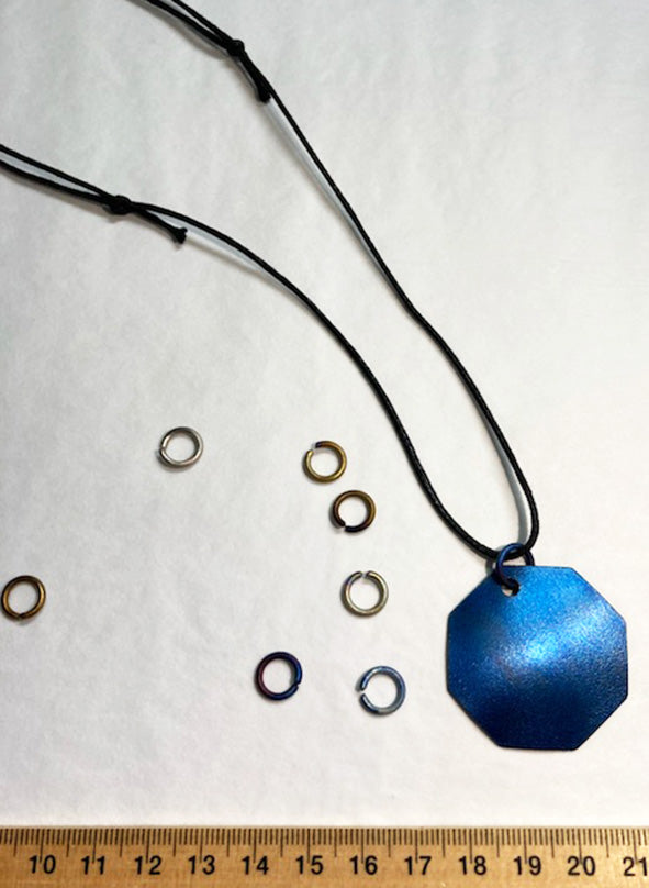 ruler next the titanium links and pendant using the link